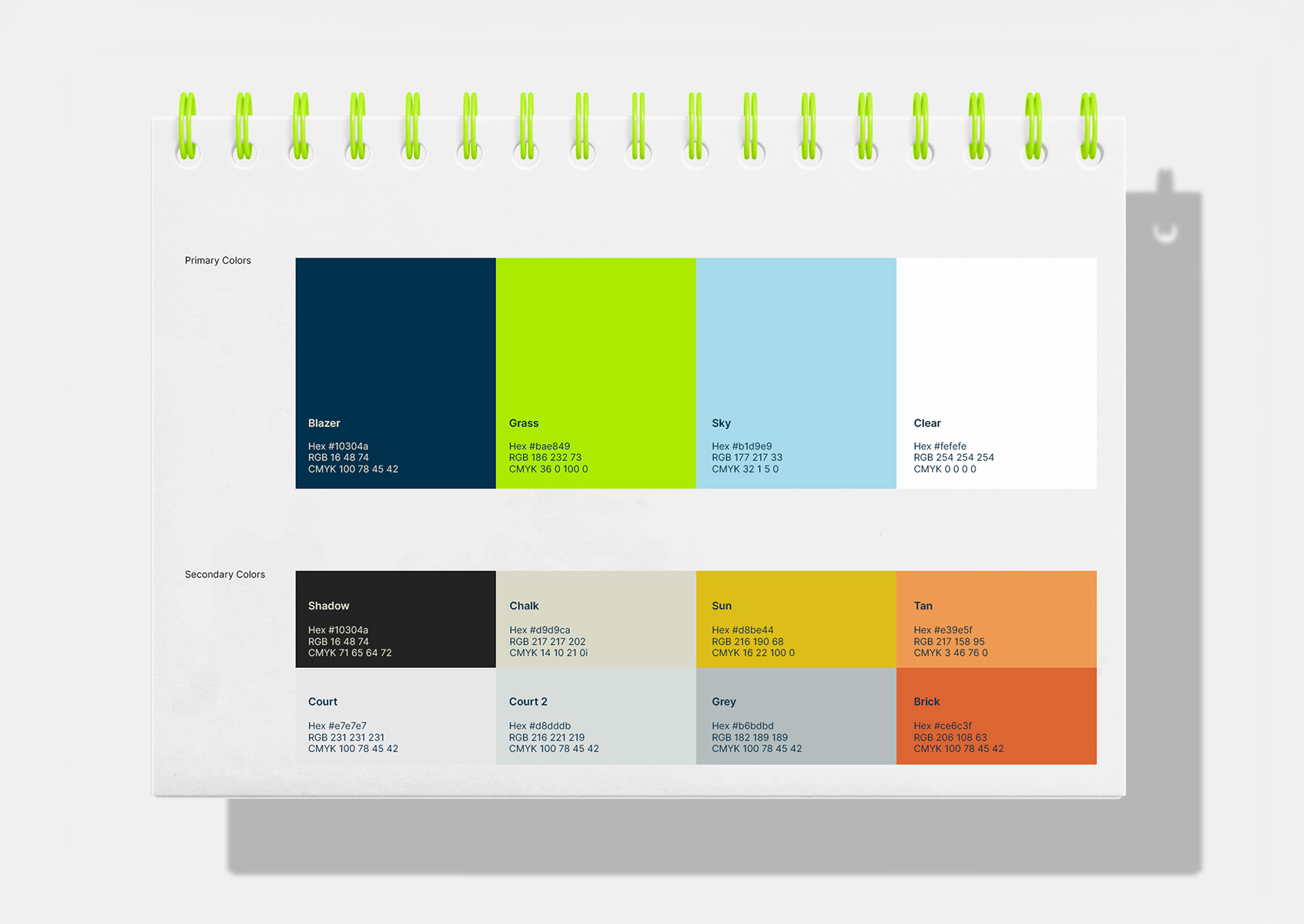 The Tennis Museum brand binder open on its colour page, the primary and secondary palettes swatched out.