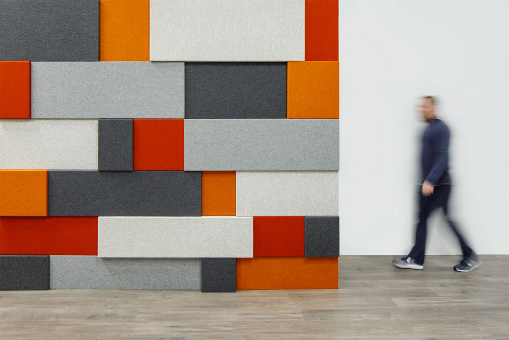 Tapestry-patterned wall panels, a figure walking past.