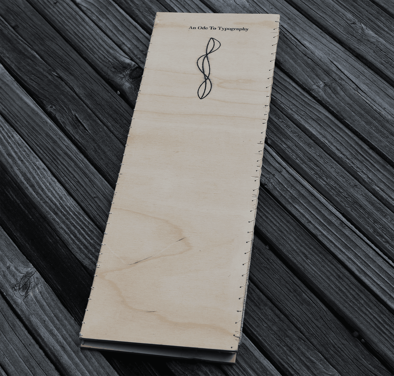The closed book on a dark wood surface.