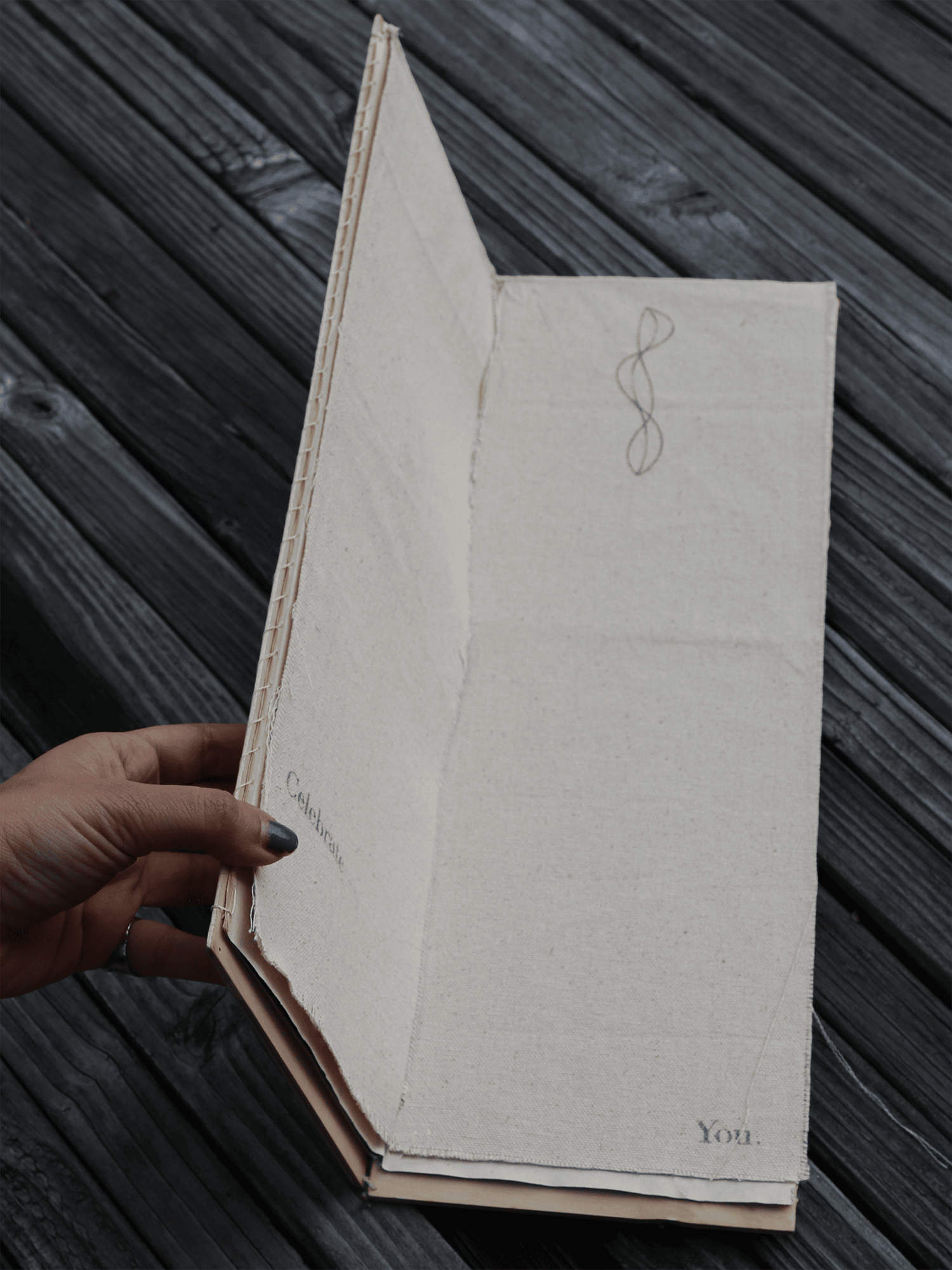 Hands holding the book open at a single page.